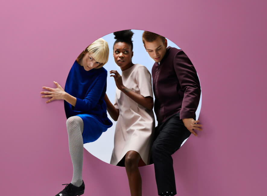 Three people stepping out of a circle inside a wall